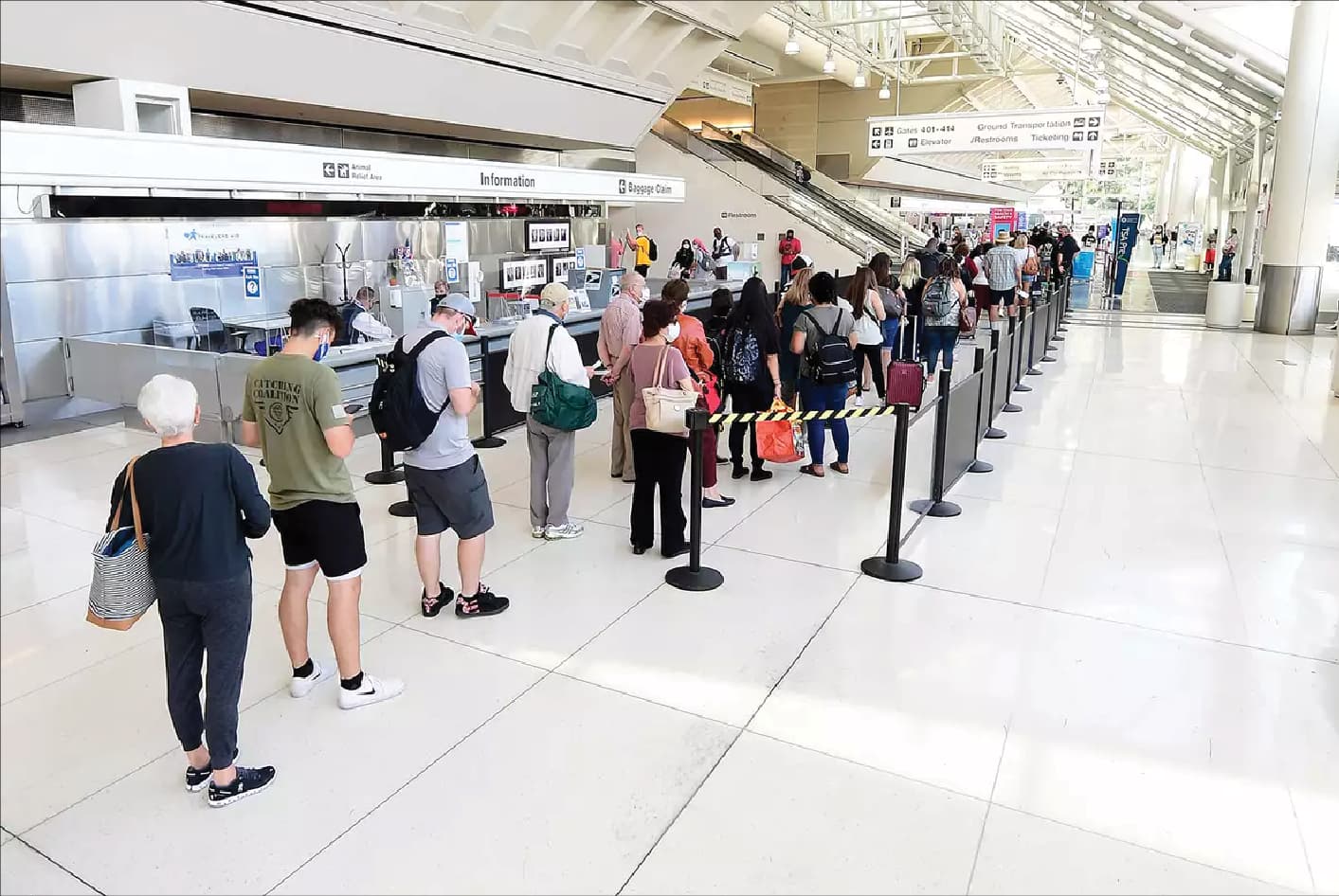 Passengers queueing at an airport security checkpoint